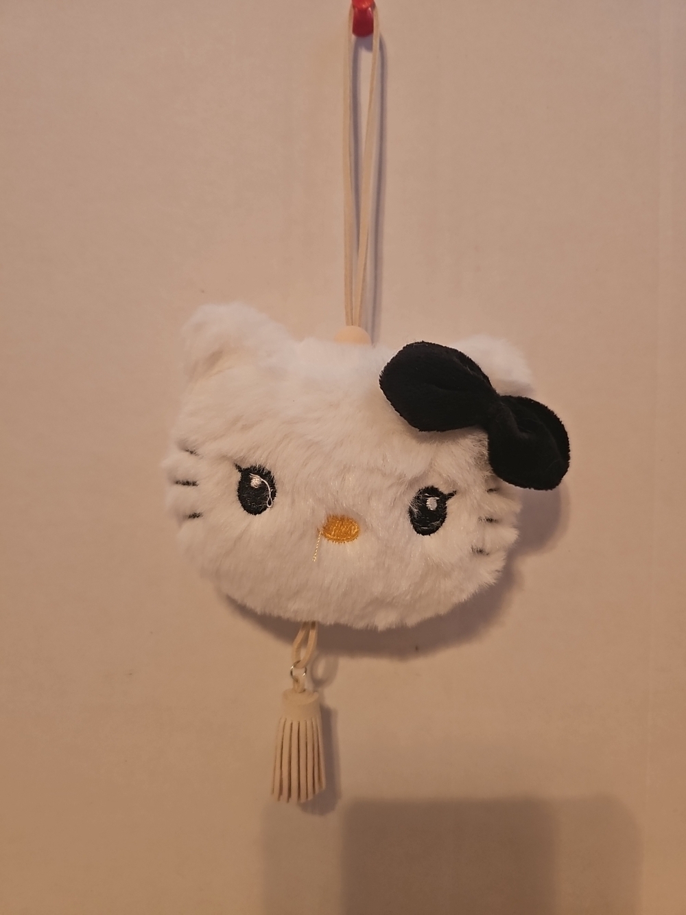 Hello Kitty plush head keychain that can also function as a bag charm